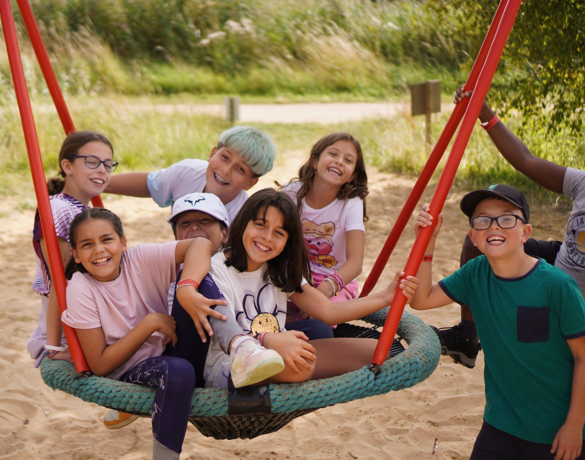 Campers smiling on a swing